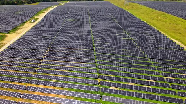 Solar panels fill a widening aerial view of renewable energy infrastructure in Virginia.