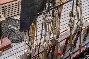 Ropes, pulleys, and rigging on old sailing ship deck © Ernesto Sevilla