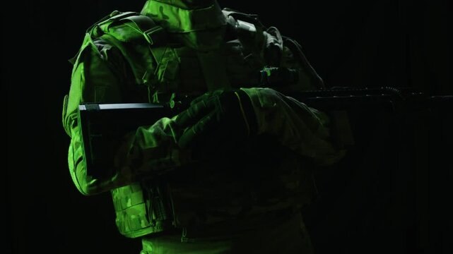 Portrait of modern soldier in military uniform and a helmet with headphones rifle, army warrior Warrior Military Gear Ready for Battle, airsoft Players in Tactical Gear and Riot Police Training
