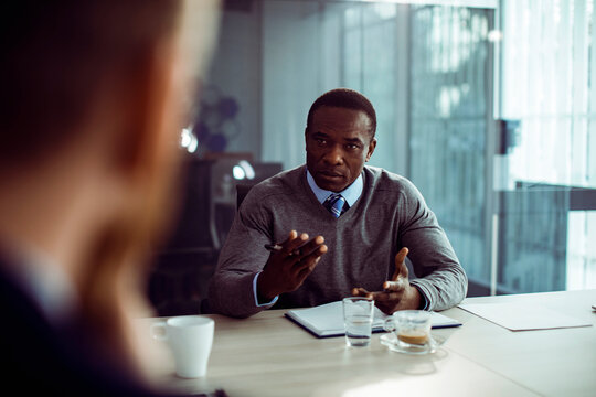 Manager interviewing candidate in conference room