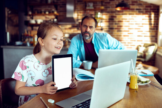 Girl showing tablet during online class at home
