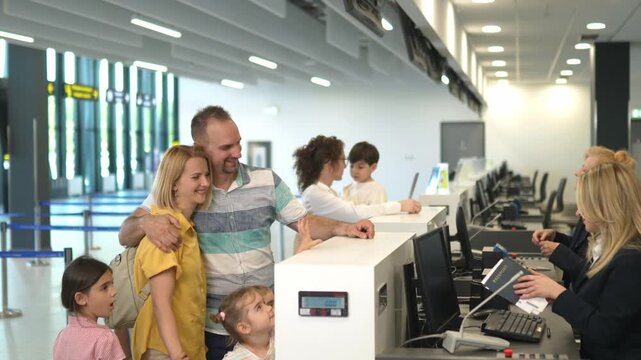 Family receiving passports at the airport check-in counter