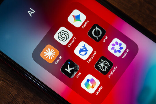 Mexico City, MEXICO - Jul 28 2026 : iPhone folder labeled AI holding Gemini, ChatGPT, Grok, Claude, DeepSeek, Meta AI, Kimi, Perplexity and Copilot app icons on a red wallpaper.