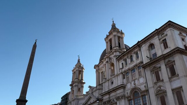 Baroque church of Sant'Agnese in Agone with domed roof and twin towers behind a fountain, Piazza Navona, Rome, Italy