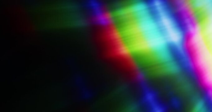 Lights shining into a prism causing an optical effect of a brilliant rainbow of dancing light rays. Light reflect creating a visual of a dreamy burst of light shining and sparkling. Seamless Loop.