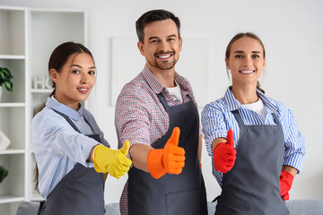 Professional cleaning service team, diverse cleaners giving thumbs up for quality home maintenance...