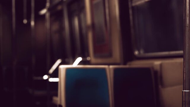 Inside a nearly empty subway train, dim light highlights the seats and surroundings. The scene captures the calmness of an evening commute, offering a moment of respite.