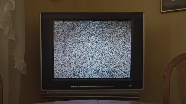 Retro tube televisions tuned to fuzzy analog static