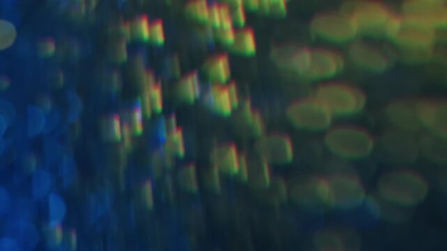 Sparkling glare art. Blurred gleam. Duplicated lens flare prism stroboscopic colorful rotation. Shiny light leak blue yellow abstract bokeh background.