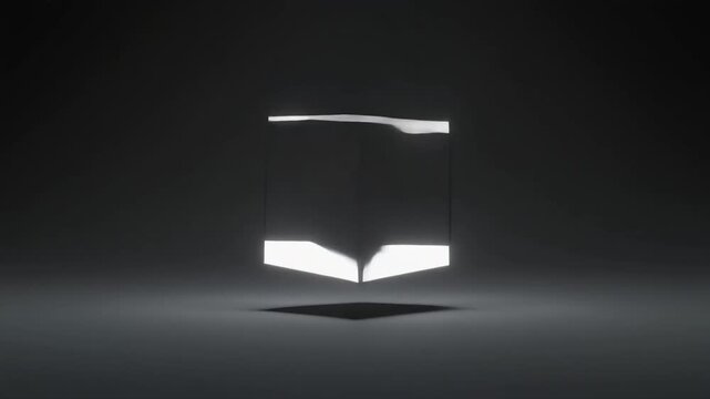 Dark gray cube with one illuminated side floating in a dark, moody environment with a subtle light reflection