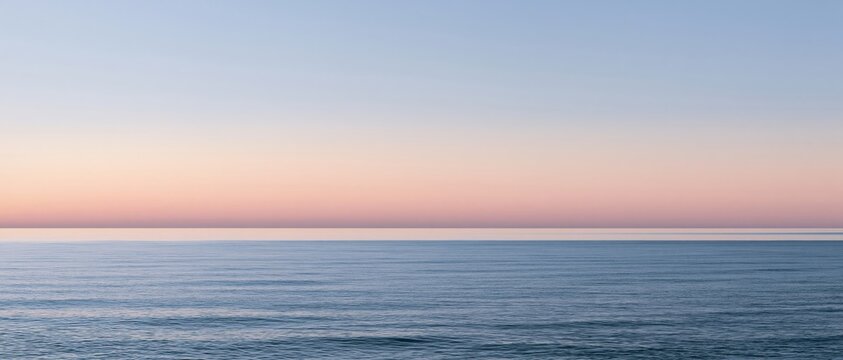 Calm sea horizon at dawn with wide cinematic composition and soft pastel sky
