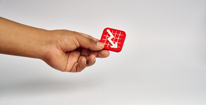 Hand holding red falling financial chart icon