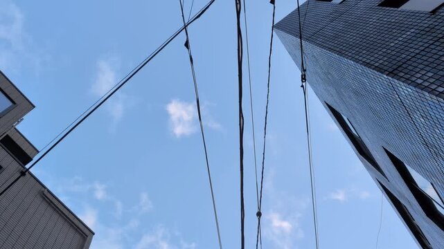 Utility poles and overhead power lines against sunset sky in Tokyo Japan