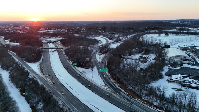 Aerial view of I-95 and US Route 202 interchange at sunset after snow in Wilmington, Delaware