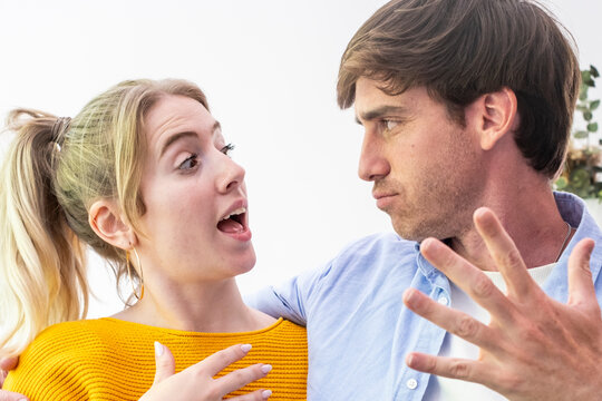 Couple having a heated argument, both showing strong emotions of anger and frustration, representing communication breakdown, stress, and misunderstanding in their relationship