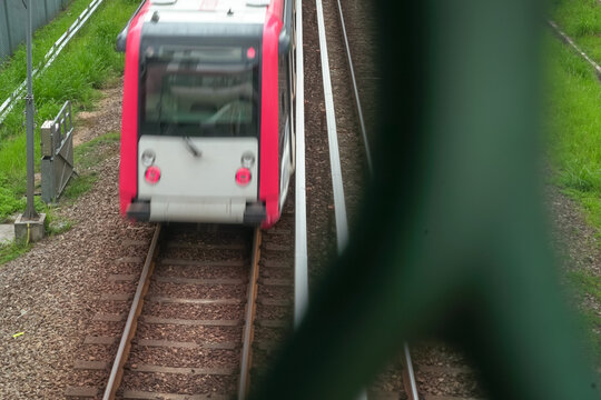 High angle view of train moving with full speed on rail tracks.