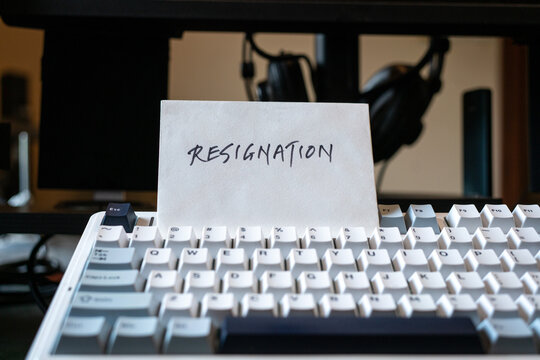 Resignation letter on top of keyboard. Quit job concept.