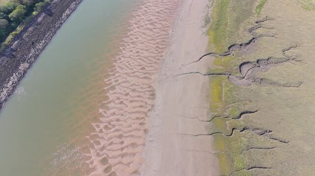 Top Down Aerial Moving Along River Neath at Low Tide with Deep Rivulets in the Sand Bank.