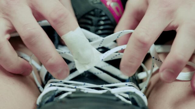 Seen head on, fingers cross and cinch laces over the skate tongue.