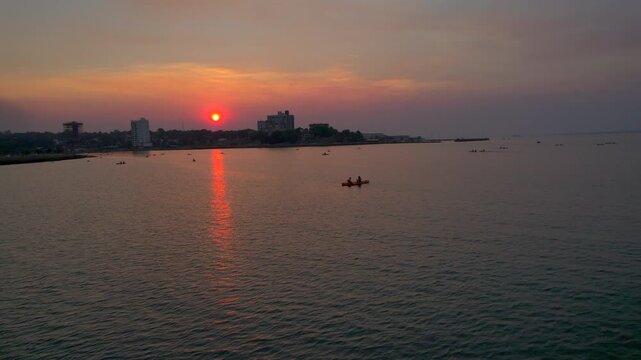 Serene sunset light illuminates kayakers paddling in Bahia El Brete, Posadas, Argentina.
