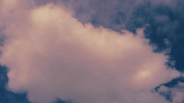 4x time Lapse footage of dreamy surreal pastel pink fluffy clouds flowing on blue sky