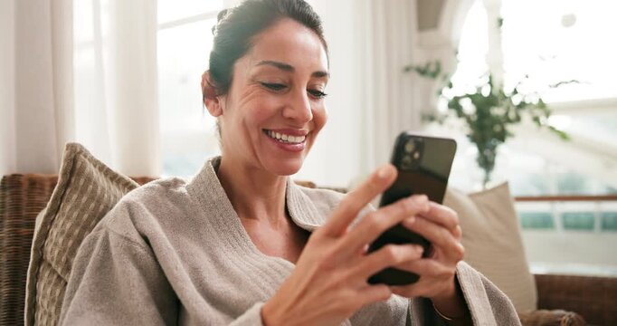 Spa, phone and mature woman with smile for hospitality rating, social media or check in at lodge. Happy person, technology and relax in waiting room with mobile app, luxury accommodation and bathrobe