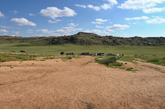 Group of off-road vehicles in the vast Mongolian steppe