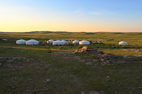 Scenic view of yurt camp in Mongolian steppe during sunrise