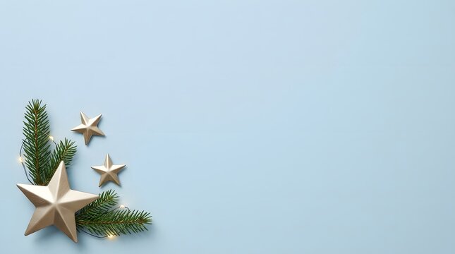 Festive winter arrangement with stars and evergreen branches on light background