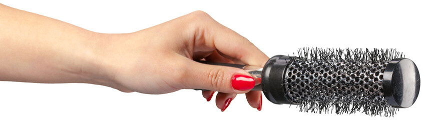 Hand holding a round hair brush for styling and grooming © fotofabrika