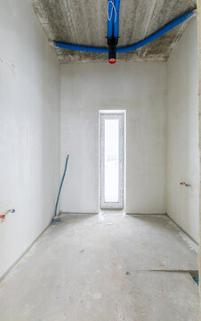 The room is under construction with a rough finish, plastered walls, concrete floor. Entrance Hall
