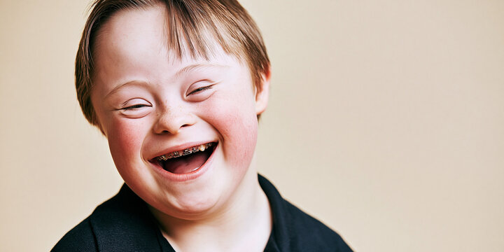 A smiling boy with Down syndrome looking happy and joyful
