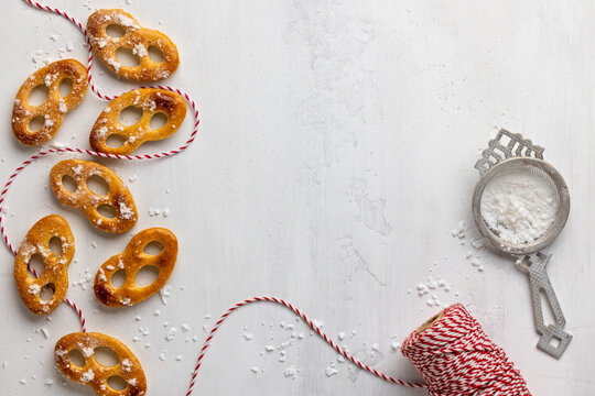Christmas sweet pretzel cookies and red twine with copy space on white background for food packaging, bakery or recipe design