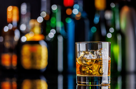 Whiskey on the rocks on a bar table