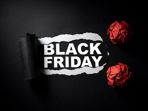 Black Friday sale concept with torn paper revealing text and crumpled paper balls