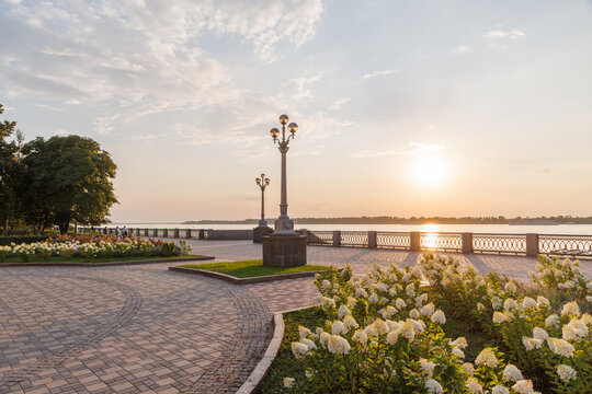 Beautiful riverside promenade with flowers at sunset