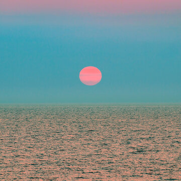 Early morning sun over rippled ocean