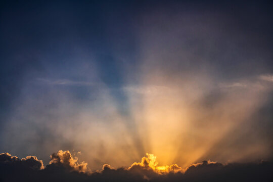 Sunbeams on sky at sunrise
