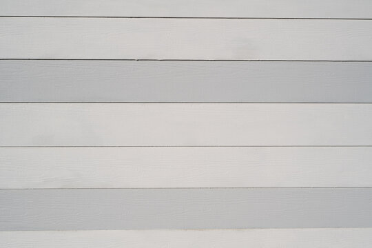 Pale grey and white horizontal wooden slats forming a repeating linear background