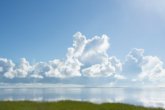 White puffy clouds over calm Saint Joseph Bay