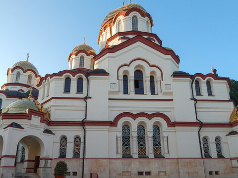 New Athos Monastery with golden domes against a clear blue sky, orthodox Christian cathedral architecture in Abkhazia