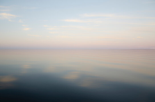 Defocused calm lake surface at sunrise