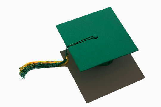 Green graduation cap on white background