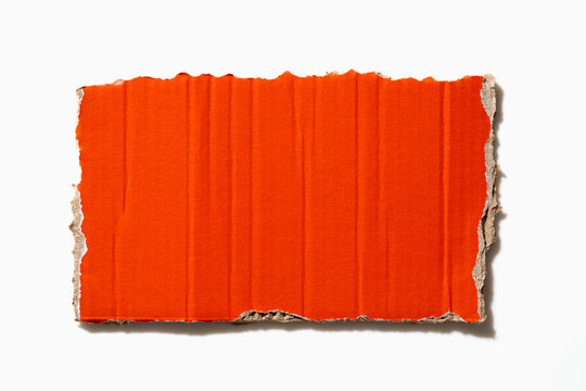 Torn orange paper on white background