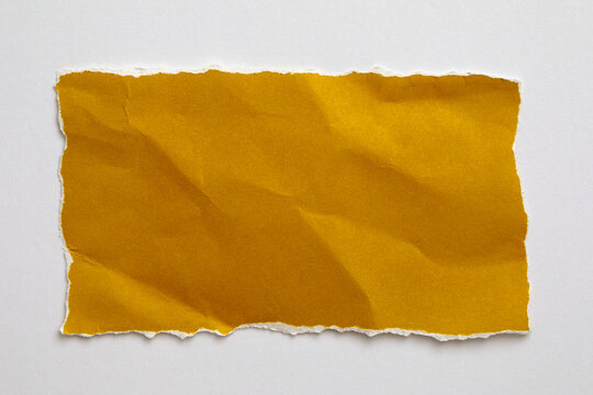 Torn yellow paper on white background