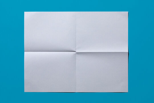 White sheet of paper on blue background