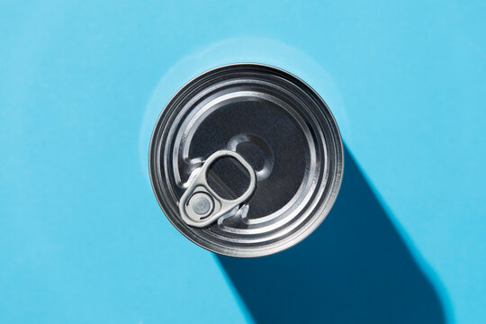 Overhead view of tin can on blue background