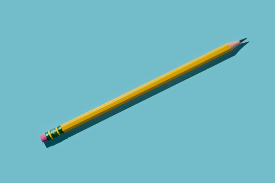 Yellow pencil on blue background