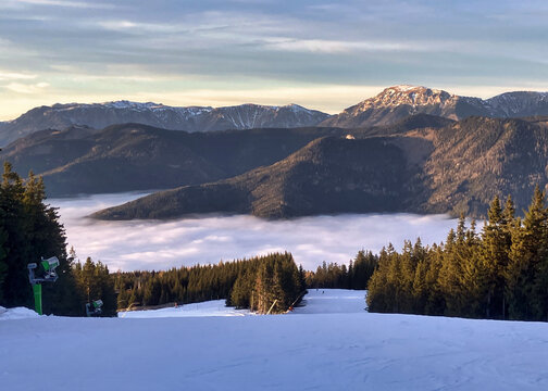 Snowy winter landscape in Austria During sunset abowe clouds. Stuhleck ski resort slope with cableway. Close to Vienna