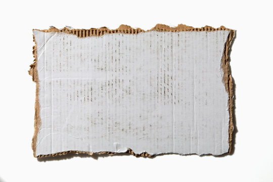 Torn white cardboard on white background